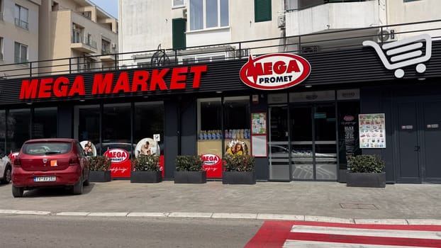 Budva, Montenegro - April 18, 2025: The Mega Market storefront features vibrant branding and a welcoming environment for shoppers.