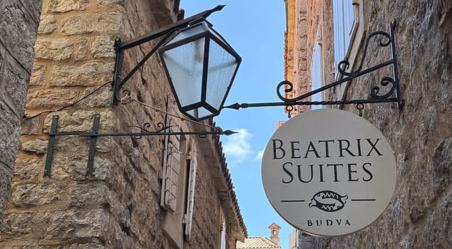 Budva, Montenegro - April 18, 2025: The inscription of the BEATRIX SUITES hotel on the wall of a building on one of the streets of the old town of Budva.