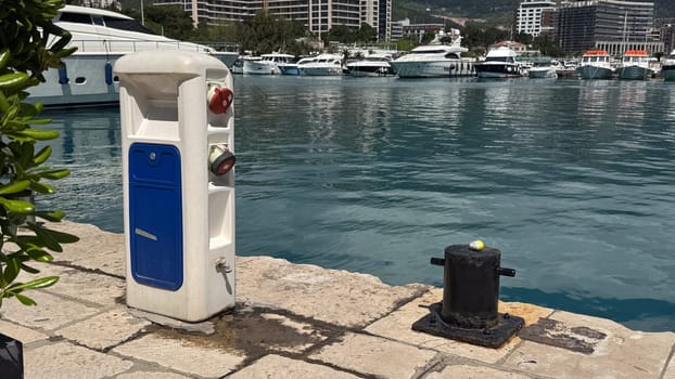 Budva, Montenegro - April 18, 2025: The docking station in the marina next to the bollard is located near luxury yachts in a calm water environment