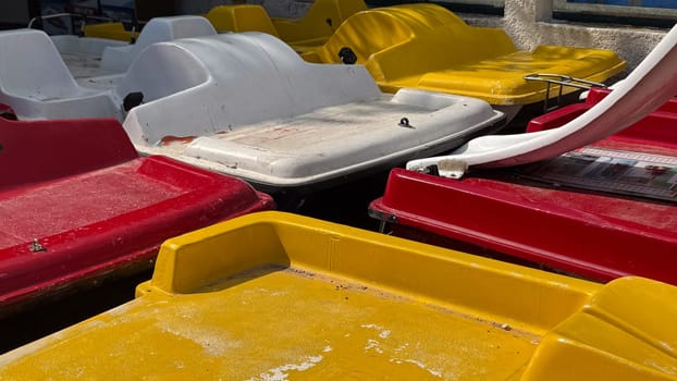 Budva, Montenegro - April 18, 2025: Colorful pedal boats are closely located on the waterfront, showcasing a vibrant outdoor theme