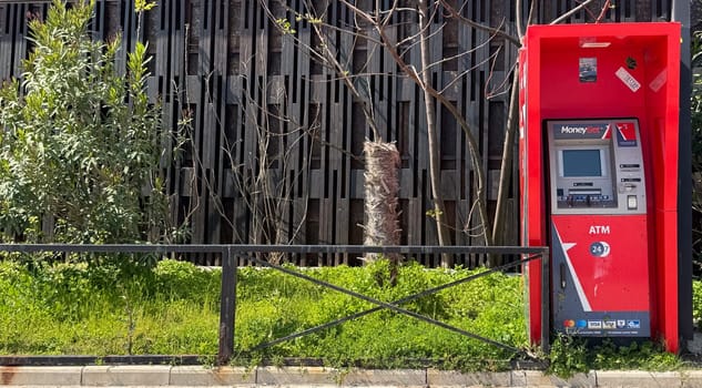 Budva, Montenegro - April 18, 2025: Red MoneyGet ATM located on the embankment of Slavyanski Beach