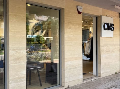 Budva, Montenegro - April 18, 2025: OVS sign at the door of the store The exterior of the OVS retail store emphasizes modern design