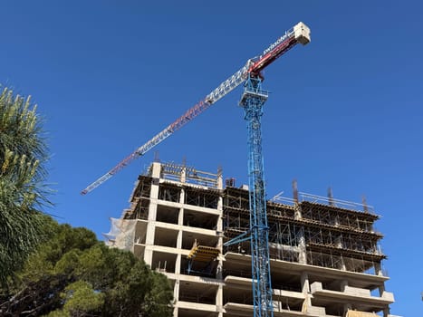 Budva, Montenegro - April 18, 2025: Swissotel construction site with crane and building under construction.Swissotel Hotels Resorts is an international chain of luxury hotels