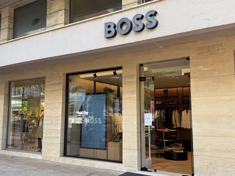 Budva, Montenegro - April 18, 2025: BOSS retail store exterior highlights contemporary fashion and design within an urban shopping area
