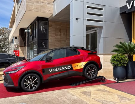 Budva, Montenegro - April 18, 2025: Red Toyota car in front of the Vulkan Slot club, as a casino prize