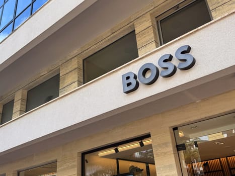 Budva, Montenegro - April 18, 2025: BOSS brand showcase located in an urban environment. architecture and retail experience.