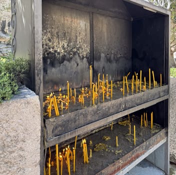 Budva, Montenegro - April 20, 2025: The tradition of lighting candles during the Easter holiday reflects a sacred space filled with hope and memories, symbolizing faith and connection with the community
