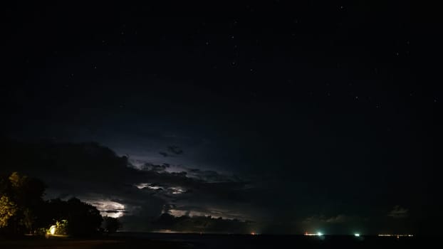 Lightning storm illuminating the night sky over a dark ocean, with bright stars twinkling above and silhouetted trees framing the scene, creating a dramatic and powerful atmosphere