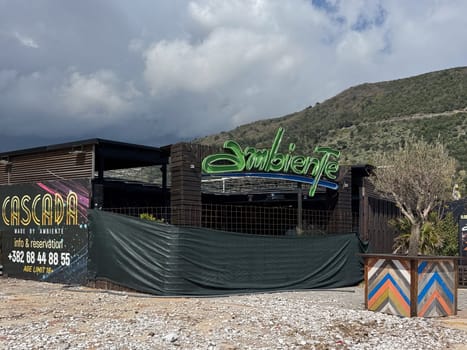 Budva, Montenegro - April 18, 2025: Located in Budva, Cascada Restaurant and Bar with a bright sign and closed with a net before the opening of the season