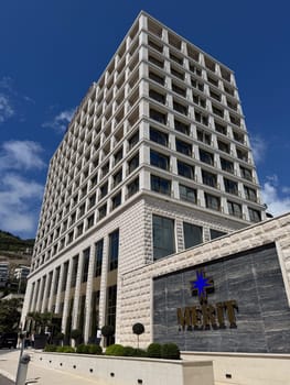 Budva, Montenegro - April 18, 2025: The modern architectural design of the Merit Hotel showcases luxurious hospitality in a beautiful location, highlighting elegance and comfort for guests seeking relaxation