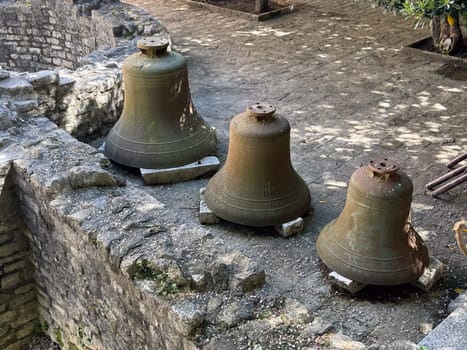Budva, Montenegro - April 18, 2025: Historical bells located on the ancient stone foundations of the Old Town, the country's heritage and cultural history