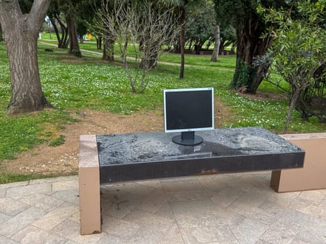 Budva, Montenegro - April 18, 2025: old LG computer monitor left on a dusty park bench
