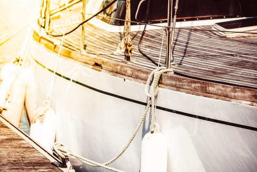 Sailboat deck ropes closeup with sunlight reflecting, suitable for nautical theme background