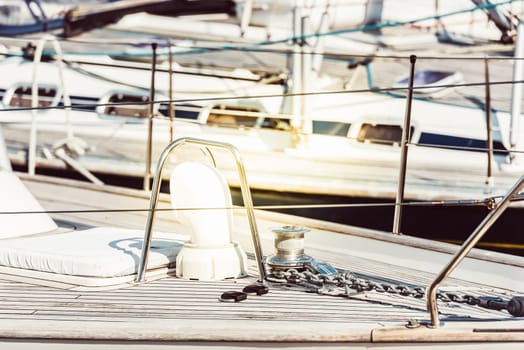 Yachts moored at marina with focus on deck details, nautical concept, sunny background