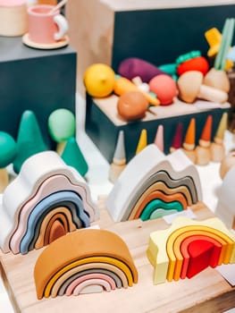 Colorful wooden rainbow toys and shapes for playful decor in playroom setting