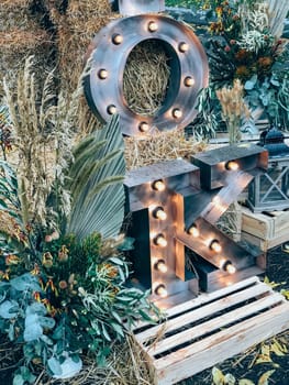 Rustic fall decor with illuminated letters in a festive autumn setting