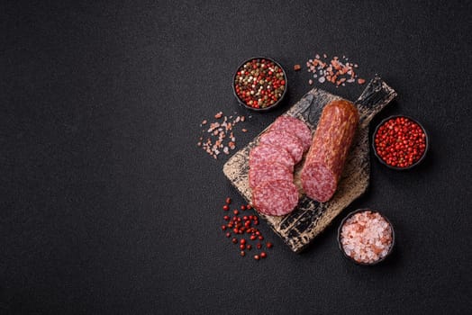 Sliced salami sausage, smoked meat, delicious deli snacks on a plate