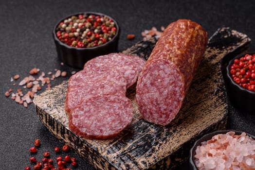 Sliced salami sausage, smoked meat, delicious deli snacks on a plate