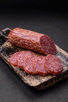 Sliced salami sausage, smoked meat, delicious deli snacks on a plate
