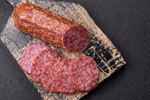 Sliced salami sausage, smoked meat, delicious deli snacks on a plate