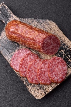 Sliced salami sausage, smoked meat, delicious deli snacks on a plate