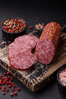 Sliced salami sausage, smoked meat, delicious deli snacks on a plate
