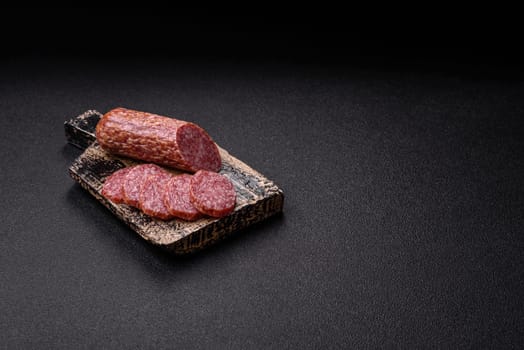 Sliced salami sausage, smoked meat, delicious deli snacks on a plate