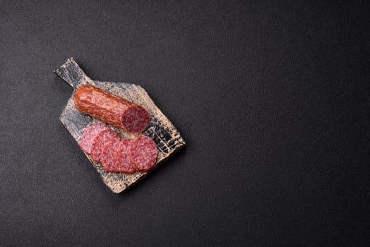 Sliced salami sausage, smoked meat, delicious deli snacks on a plate