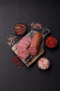 Sliced salami sausage, smoked meat, delicious deli snacks on a plate
