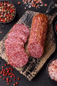 Sliced salami sausage, smoked meat, delicious deli snacks on a plate