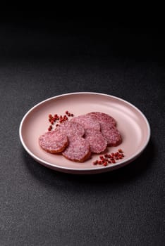 Sliced salami sausage, smoked meat, delicious deli snacks on a plate
