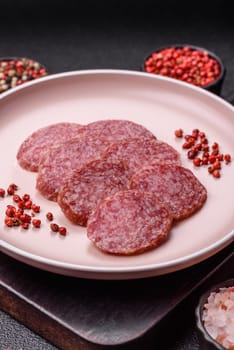 Sliced salami sausage, smoked meat, delicious deli snacks on a plate