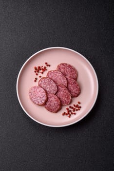 Sliced salami sausage, smoked meat, delicious deli snacks on a plate