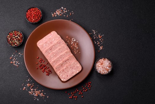Canned ham, meat, pork, with spices and salt, slices on a dark concrete background