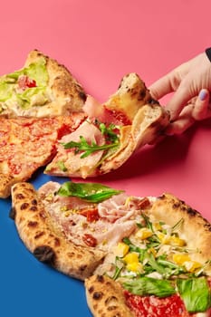 Hand grabbing a slice of pizza with assorted toppings, showcasing a vibrant and appetizing culinary experience