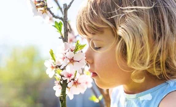 Child in a garden of flowering trees. Selective focus. kid.