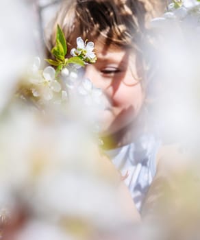 Child in a garden of flowering trees. Selective focus. kid.