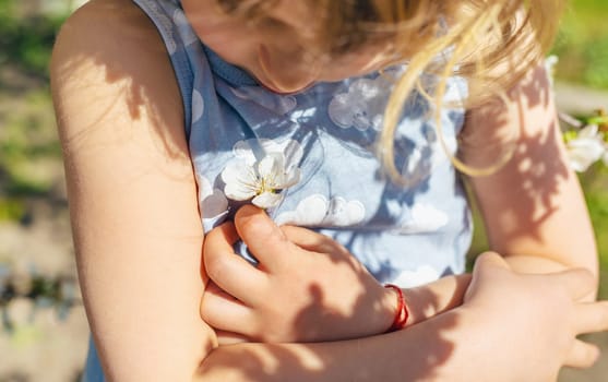 Child in a garden of flowering trees. Selective focus. kid.