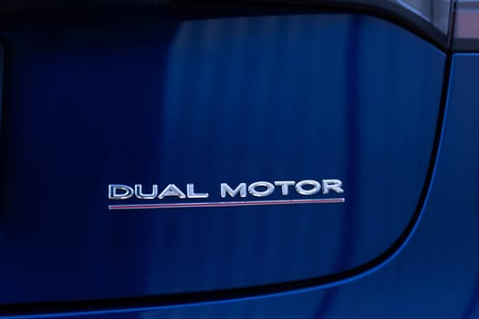 Lviv, Ukraine - April 17, 2025: Tesla Model 3 dual motor performance logo rear view. Electric car parked on parking lot.