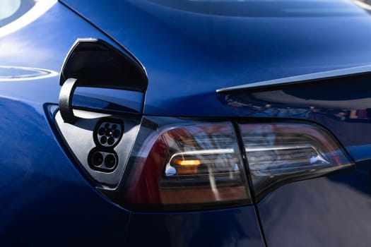 Fast charging socket type 2 combo electric car. Type 2 CCS plug port on electric vehicle. DC - CCS type 2 EV charging connector at EV car. Eco friendly alternative energy green environment concept