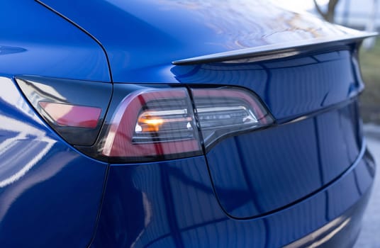Emergency flashing car rear light lamp. Car emergency light signal, warning sign. Nobody around to help. Tail light signals for turning a car on the street. Car on the road with tail left yellow light