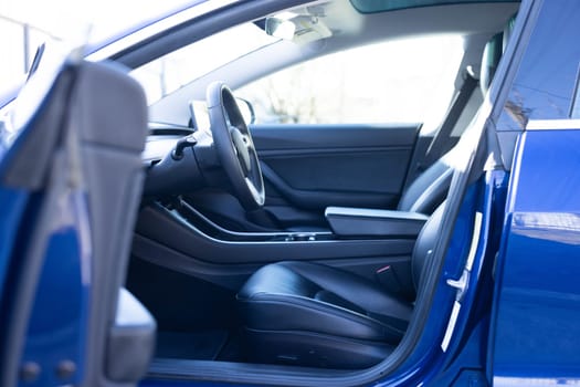 Car interior luxury inside. Steering wheel, dashboard, speedometer, display. Black leather interior. Modern luxury car Interior - steering wheel, shift lever and dashboard.