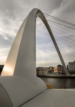 Newcastle, UK - Apr 11, 2025 - Perspective of The Iconic gateshead millennium bridge spanning the River Tyne with ancient buildings and sky in the background before sunset in Newcastle Upon Tyne in the North East of England. The pedestrian bridge, use it as your Wallpaper, Poster and Space for text, Selective focus.