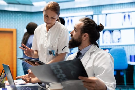 Medical staff collaborates on diagnostic procedures and treatment plans. Radiology specialists work on accurate diagnosis and effective disease prevention, healthcare industry insurance.