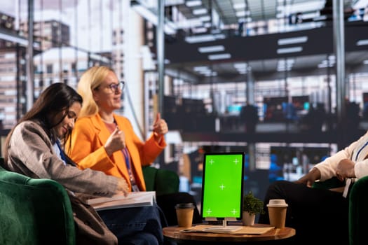 Group of diverse colleagues sharing ideas to achieve greatness in a men dominated business industry, using an isolated chroma key screen. Female leaders working together for a success story.