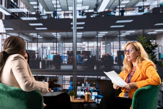 Female CEOs and managers discussing data management and business strategies using their influence and resilience for achieve greatness in a men dominated environment. Corporate feminism.