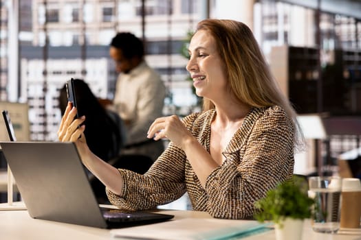 Entrepreneur connects with her business partners in a virtual meeting, discussing financial investments and growth opportunities. The video call enables strategic planning and partnership success.