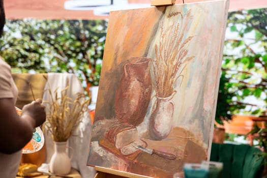 Male artist working on his new masterpiece for the fine art gallery exhibition, using a certain painting technique during his creative process. Beautiful creation on a canvas.