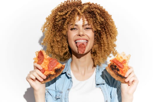 Energetic woman with curly hair playfully eating pepperoni pizza, embodying joy and indulgence, perfect for food related themes and seasonal festivities