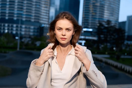 Empowering image of a business woman exuding confidence, dressed in chic attire against an urban landscape, perfect for conveying professionalism and ambition.
